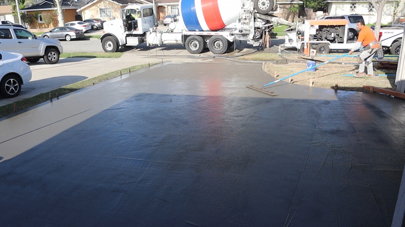 Fresh concrete driveway being poured by professionals in Greenacres, FL